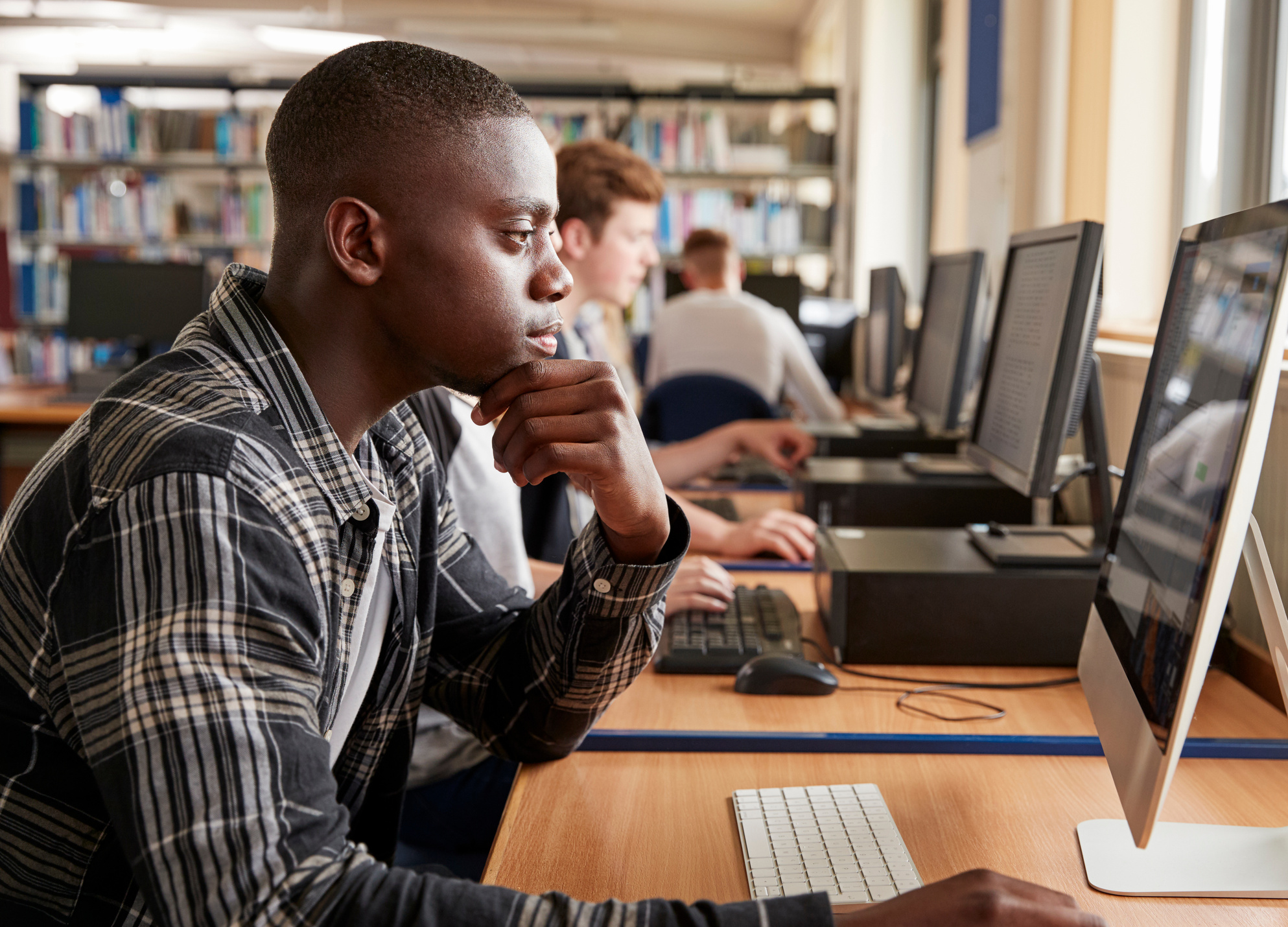 Male Student Working on Computer in College Library